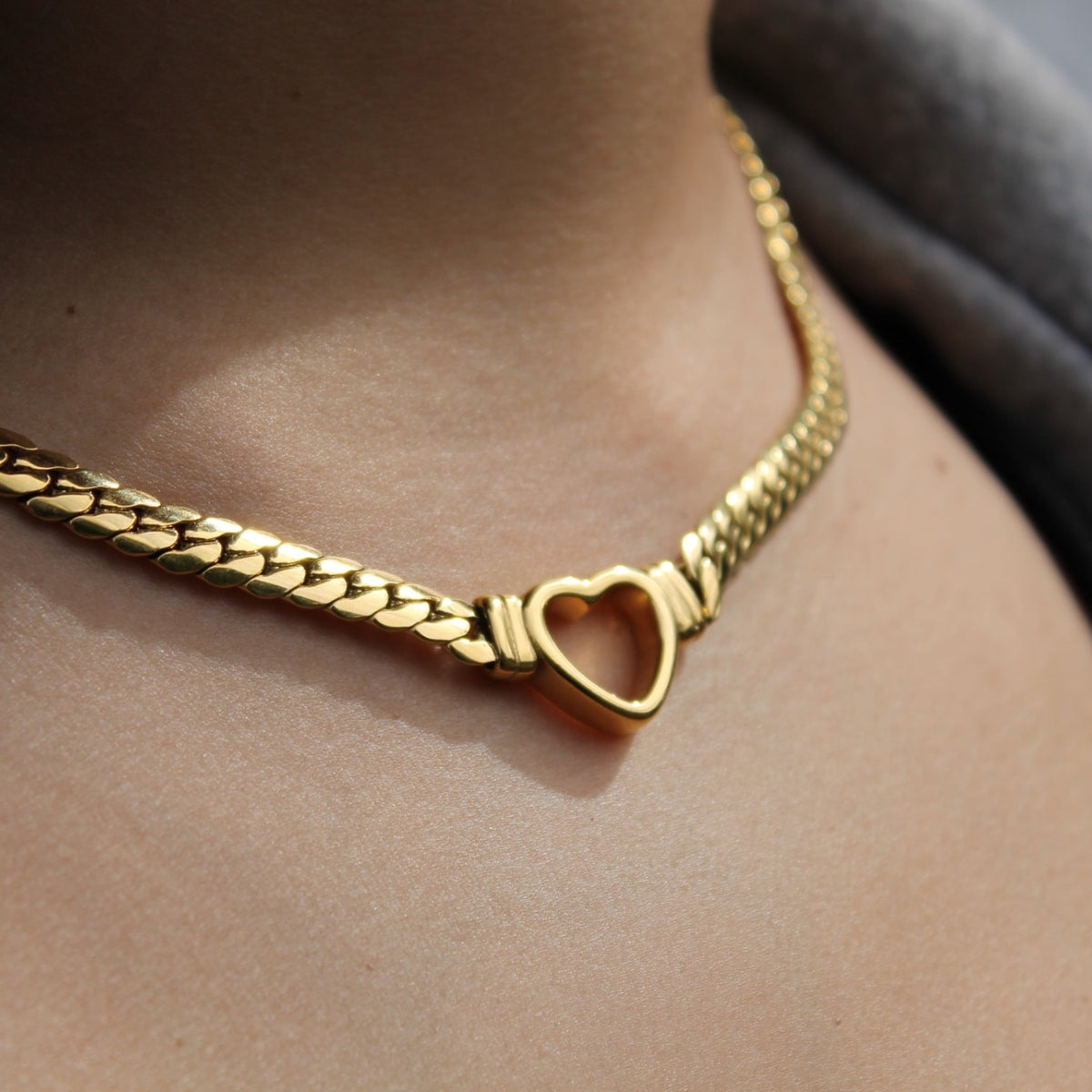 Aurelia Heart Chain in gold at the collarbone (placeholder for The Daily Pair)