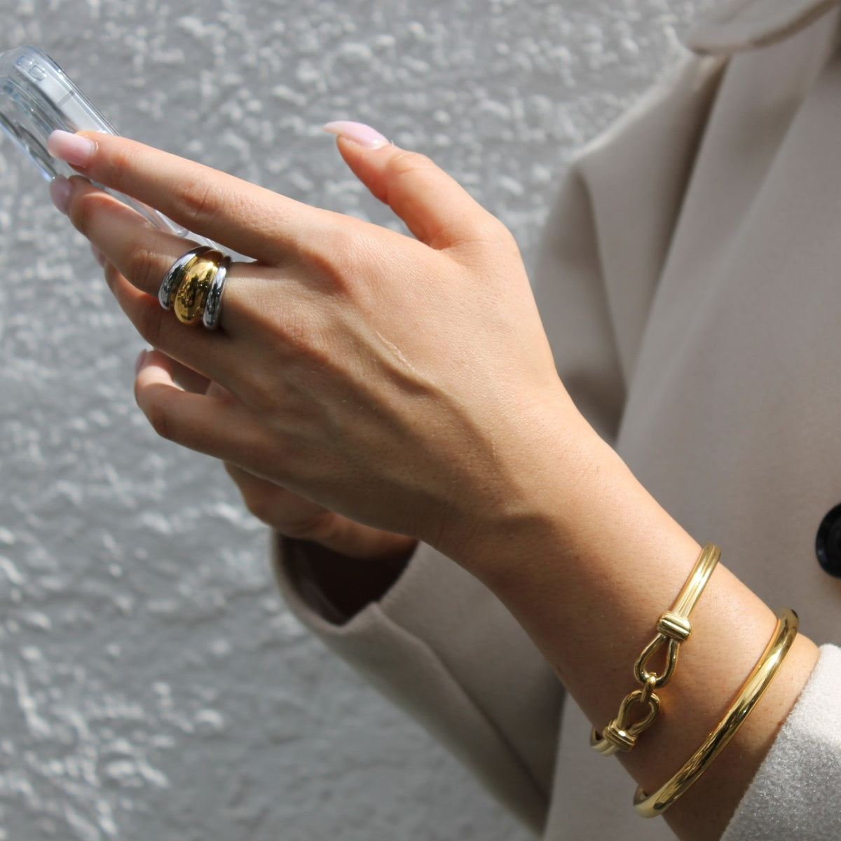 Two-Tone Ribbed Ring with the Infinity Knot Bangle and Solid Round Gold Bangle worn together (placeholder for The Wrist Stack)